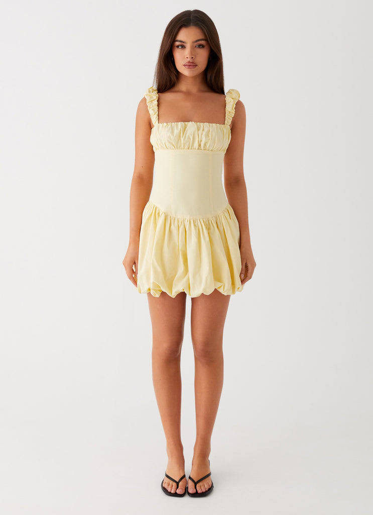 Womens Clove Mini Dress in the colour Yellow in front of a light grey background