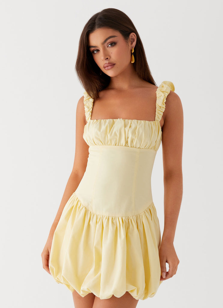 Womens Clove Mini Dress in the colour Yellow in front of a light grey background