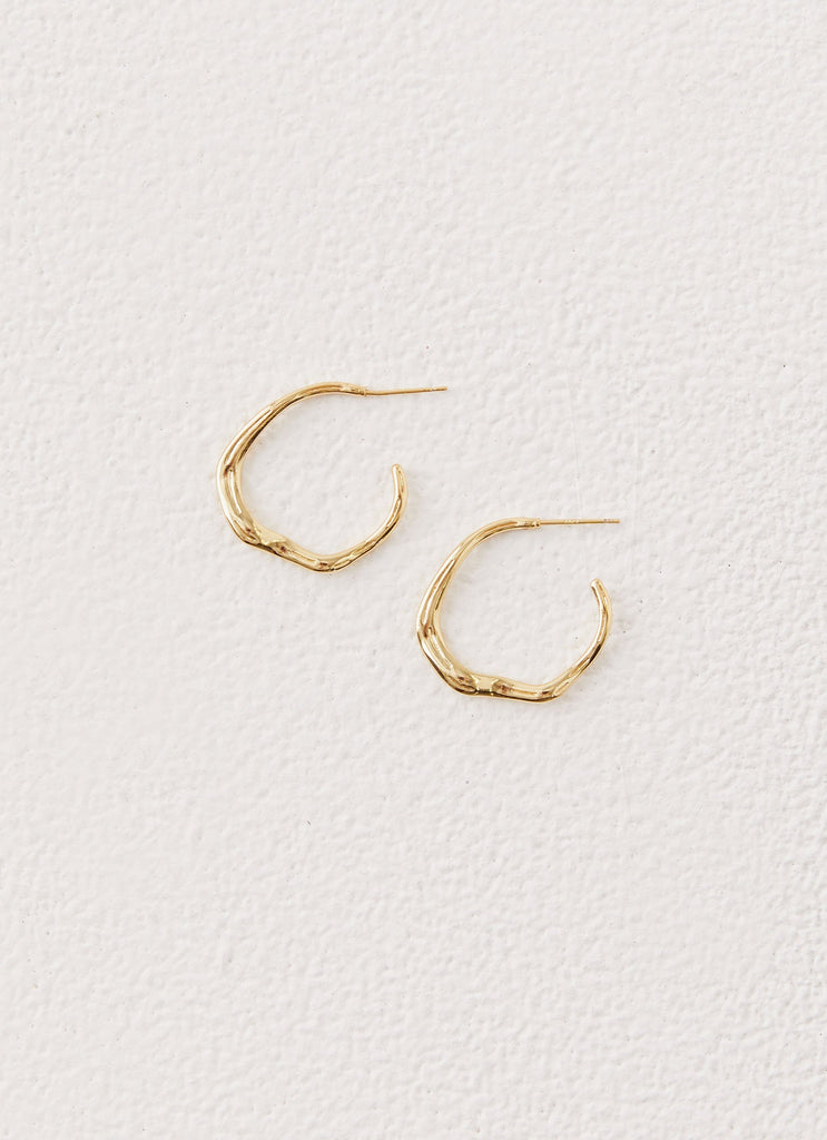 Womens Etta Hoop Earrings in the colour Gold in front of a light grey background