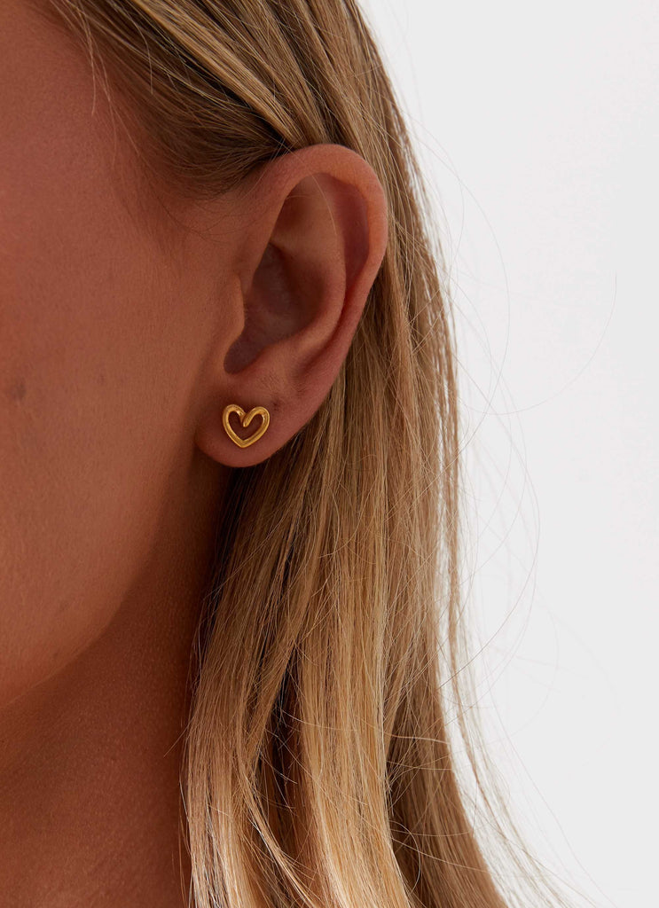 Womens Issie Heart Earrings in the colour Gold in front of a light grey background