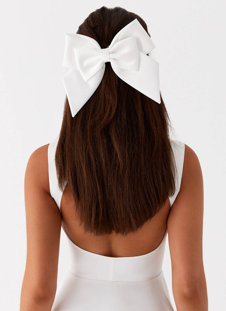 Womens Lucky In Love Bow Hair Clip in the colour White in front of a light grey background