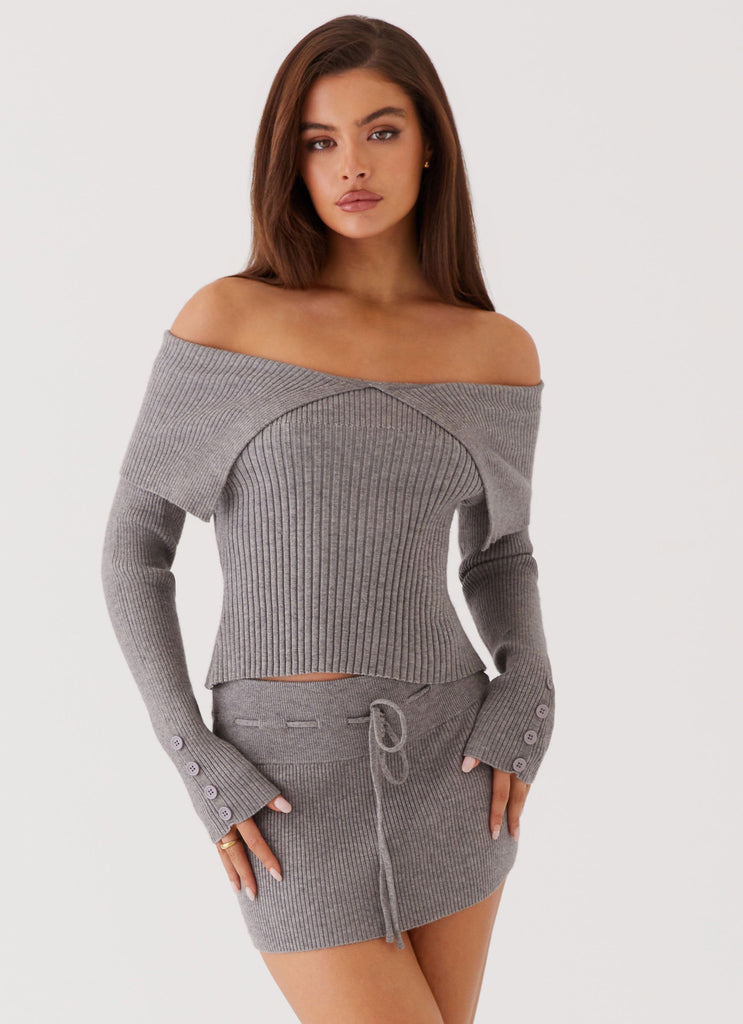 Womens Frankie Arrow Knit Long Sleeve Top in the colour Charcoal in front of a light grey background