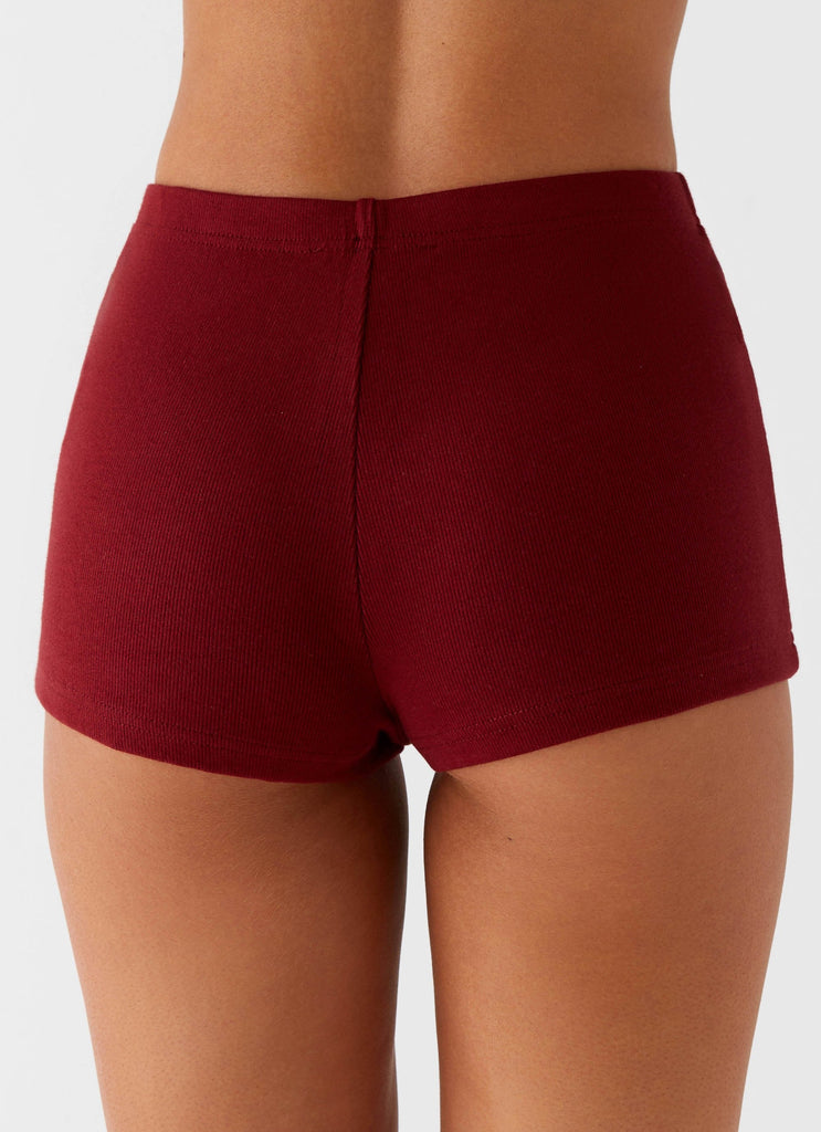 Womens Spectate Mini Shorts in the colour Maroon in front of a light grey background