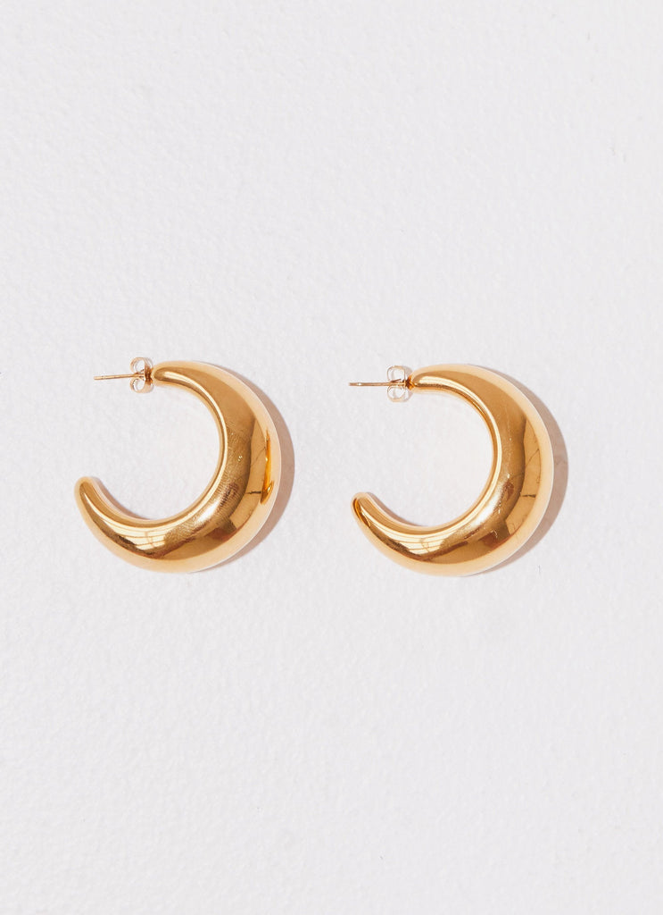 Womens Bon Voyage Hoop Earrings in the colour Gold in front of a light grey background