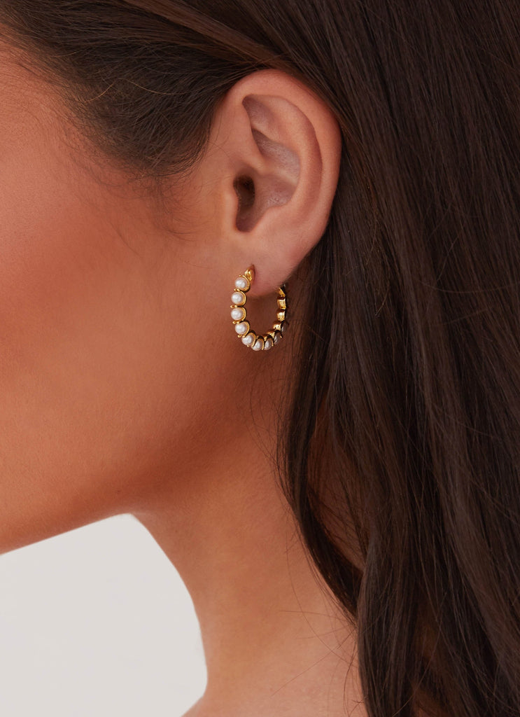 Womens Kinsley Pearl Hoop Earring in the colour Gold in front of a light grey background