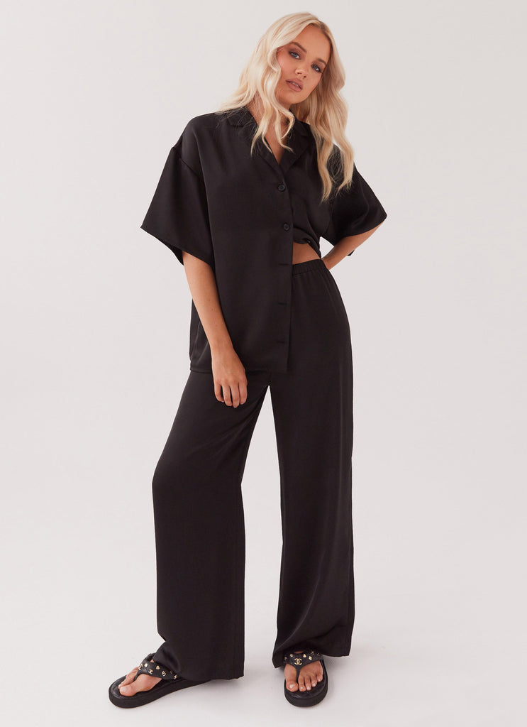 Womens Palm Cove Satin Pants in the colour Black in front of a light grey background