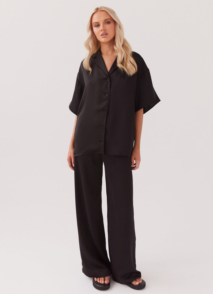 Womens Palm Cove Satin Shirt in the colour Black in front of a light grey background