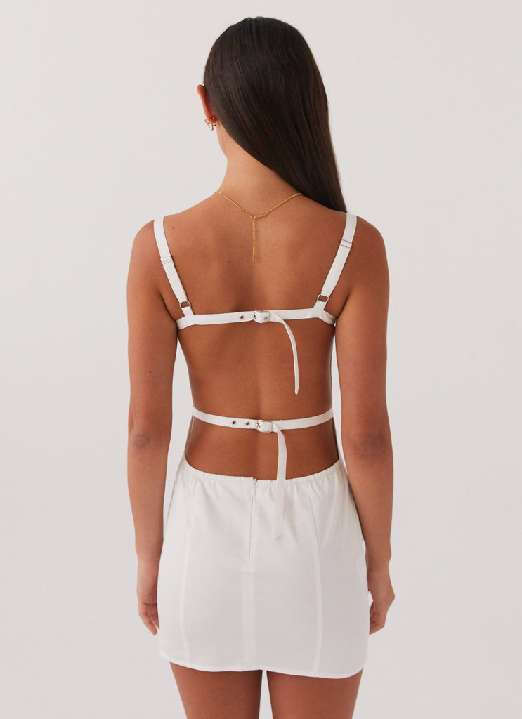 Womens Naomi Backless Mini Dress in the colour White in front of a light grey background