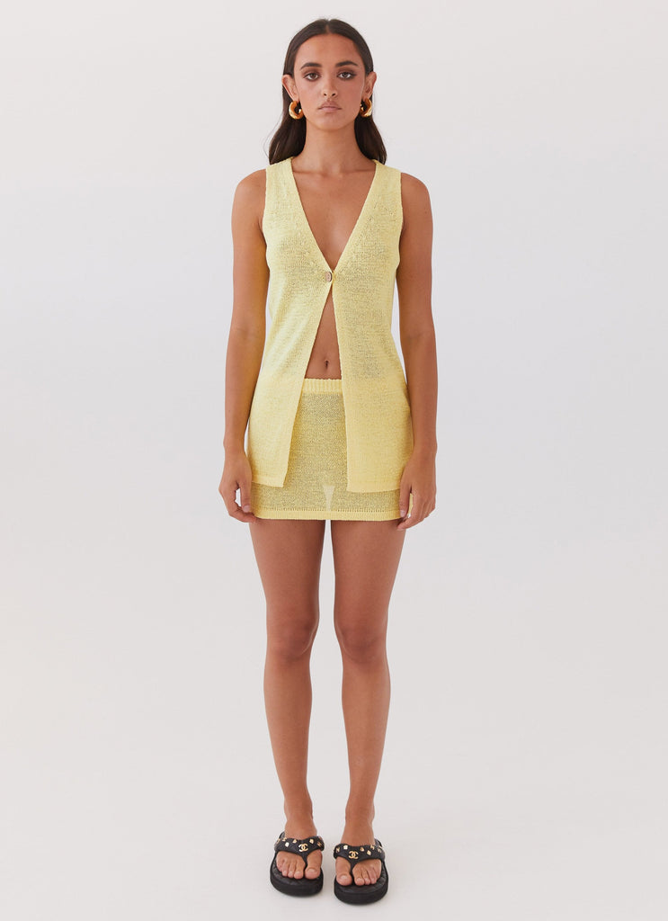 Womens Capri Glow Knit Mini Skirt in the colour Canary in front of a light grey background