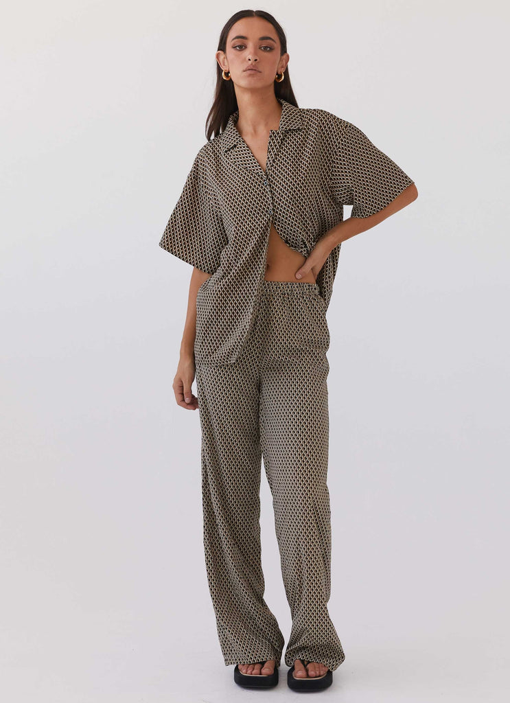 Womens Bruno Wide Leg Pants in the colour Brown Geo in front of a light grey background