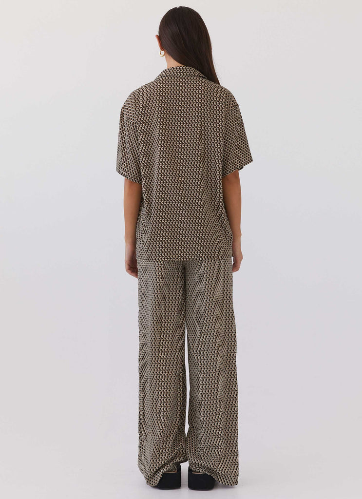 Womens Bruno Wide Leg Pants in the colour Brown Geo in front of a light grey background