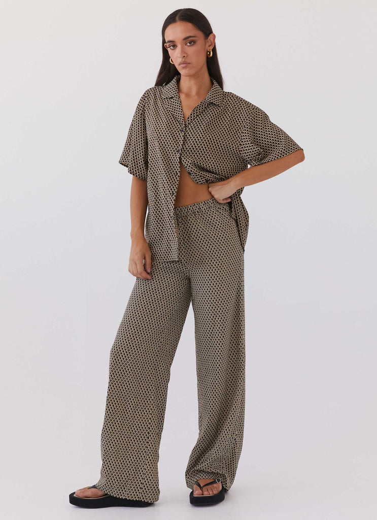 Womens Bruno Wide Leg Pants in the colour Brown Geo in front of a light grey background