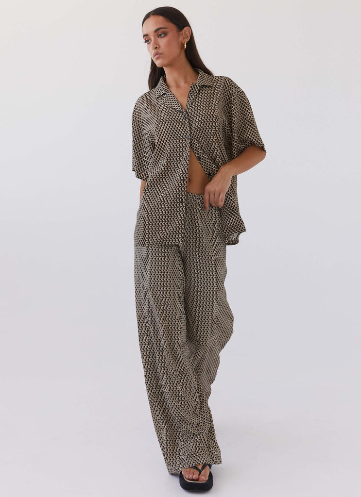 Womens Bruno Wide Leg Pants in the colour Brown Geo in front of a light grey background