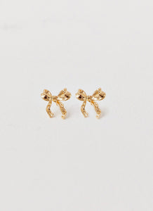 Womens Kindra Mini Bow Earring in the colour Gold in front of a light grey background