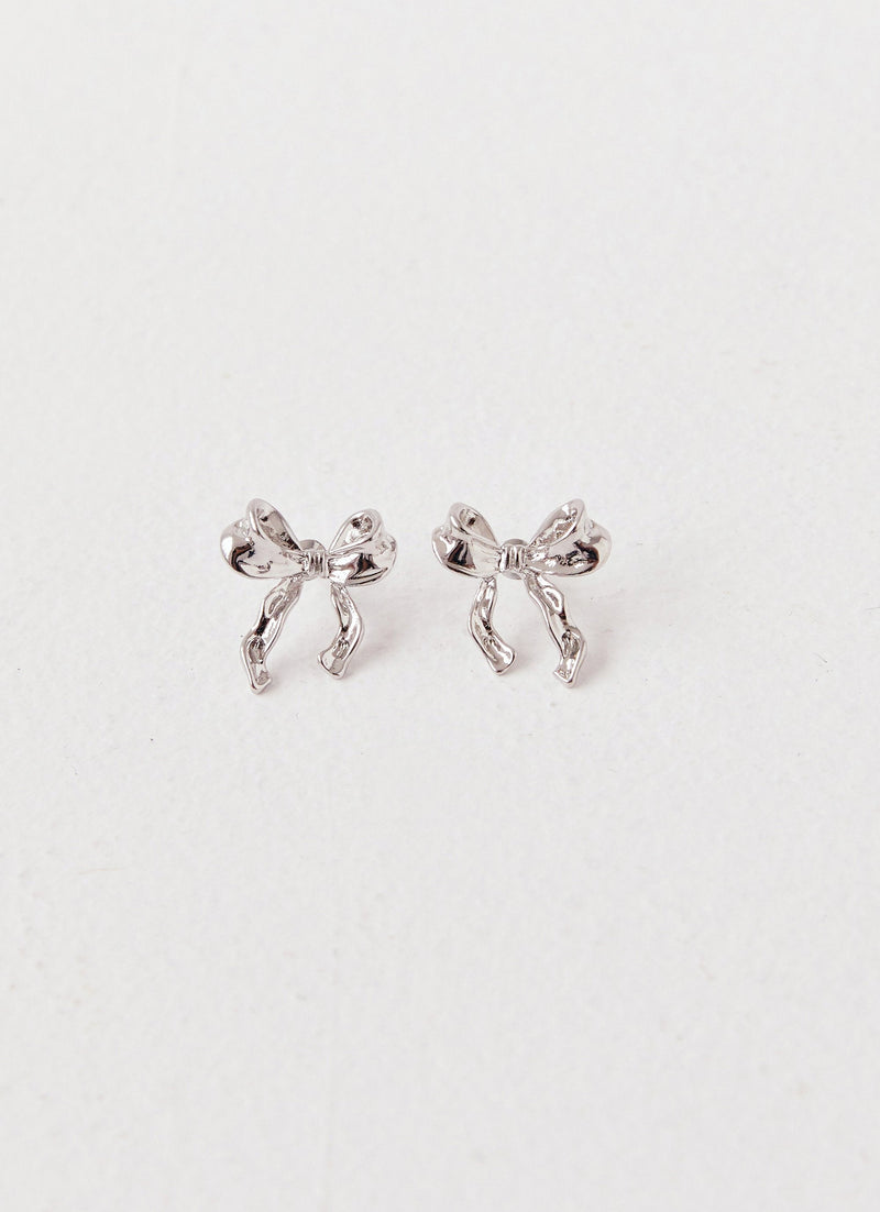 Womens Kindra Mini Bow Earring in the colour Silver in front of a light grey background