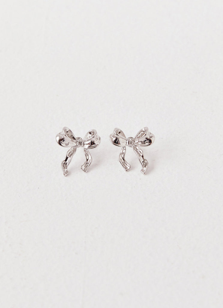 Womens Kindra Mini Bow Earring in the colour Silver in front of a light grey background