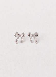 Womens Kindra Mini Bow Earring in the colour Silver in front of a light grey background