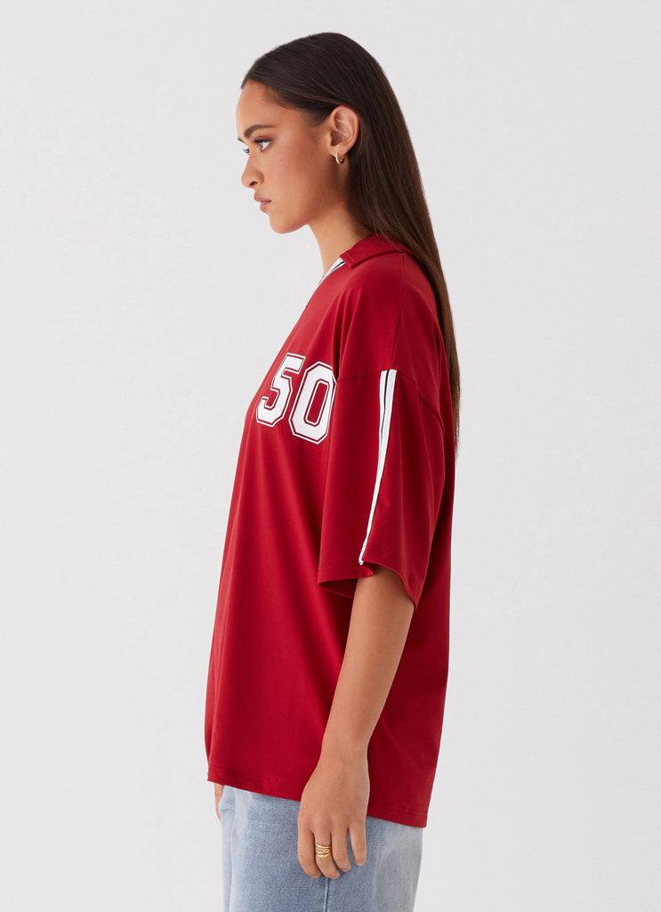 Womens Jayde Jersey Top in the colour Maroon in front of a light grey background