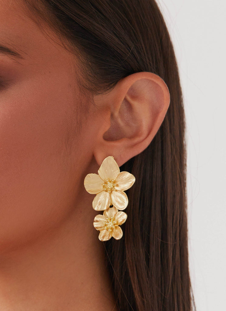 Womens Lola Love Flower Earrings in the colour Gold in front of a light grey background