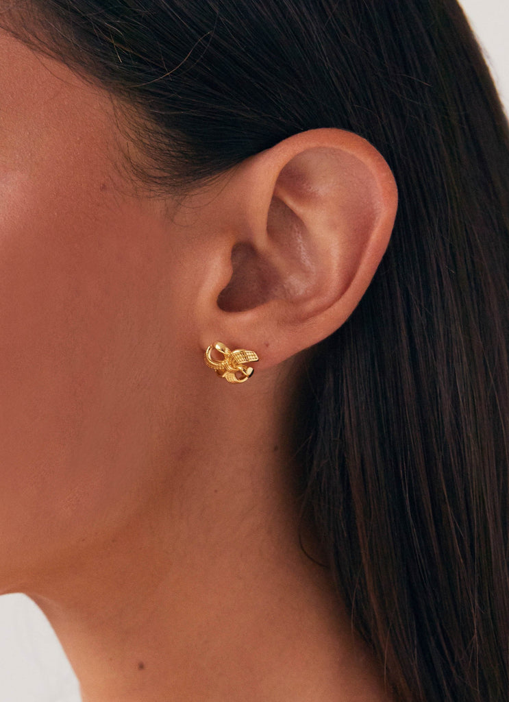 Womens Theodora Mini Earring in the colour Gold in front of a light grey background