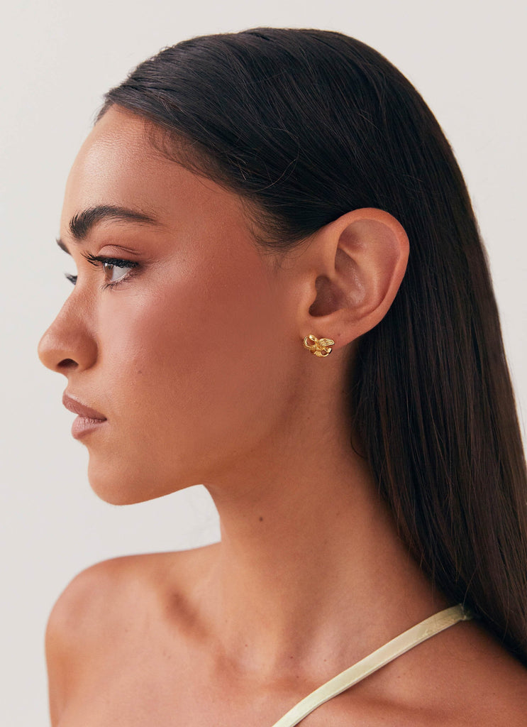 Womens Theodora Mini Earring in the colour Gold in front of a light grey background