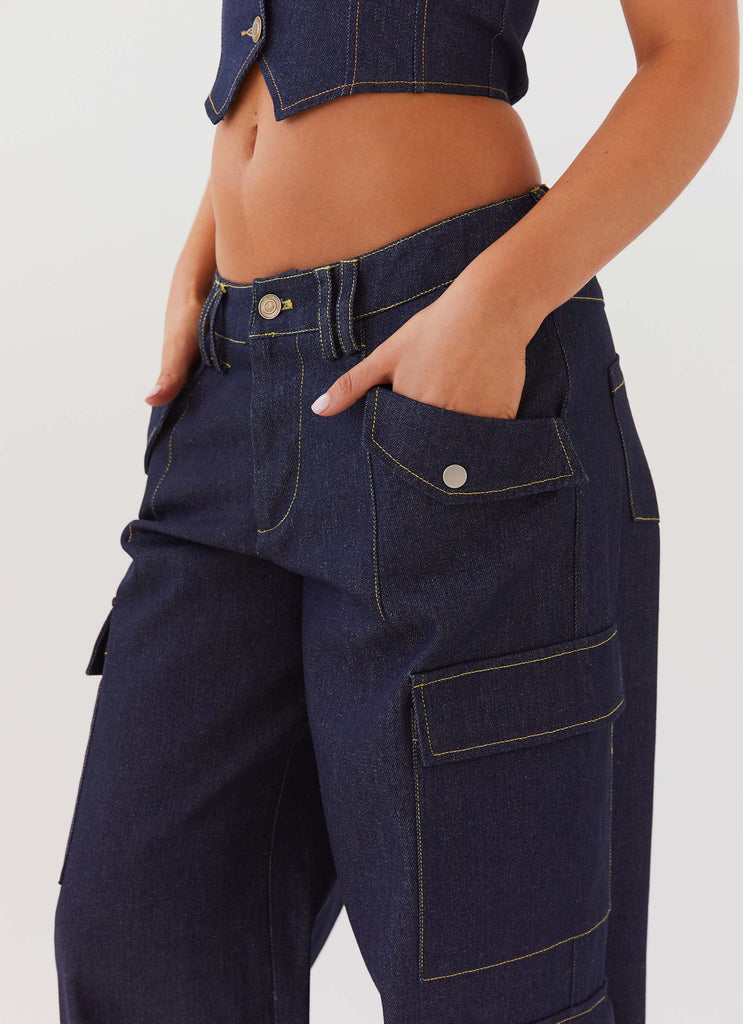 Womens Greedy Denim Cargo Pants in the colour Indigo in front of a light grey background