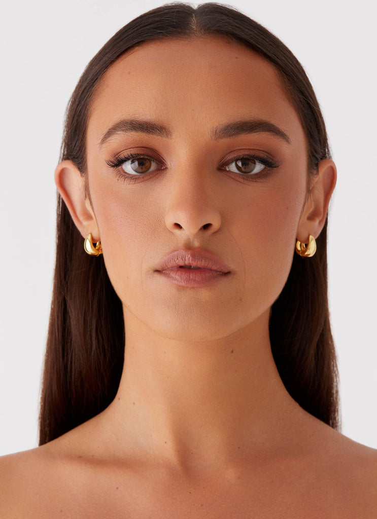 Womens Dome Teardrop Earrings in the colour Gold in front of a light grey background