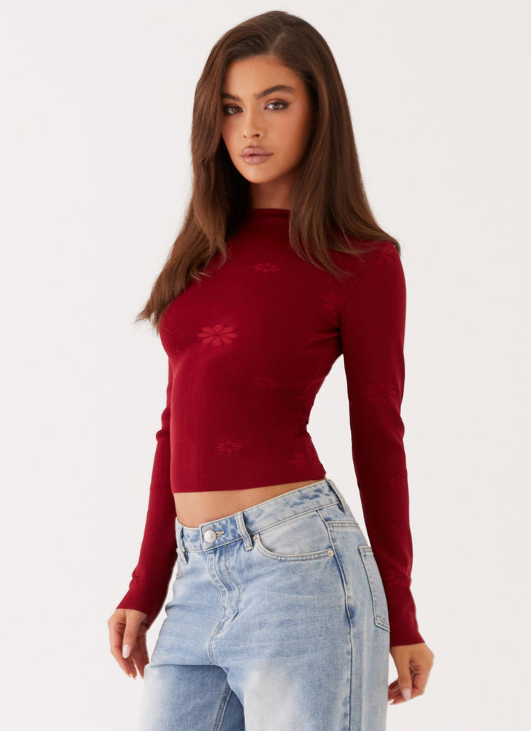 Womens Dandelion Long Sleeve Knit Top in the colour Red in front of a light grey background