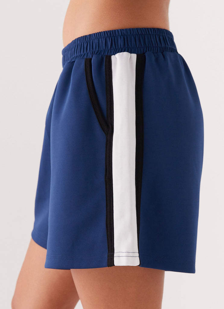 Womens Feel The Rush Track Shorts in the colour Vintage Blue in front of a light grey background