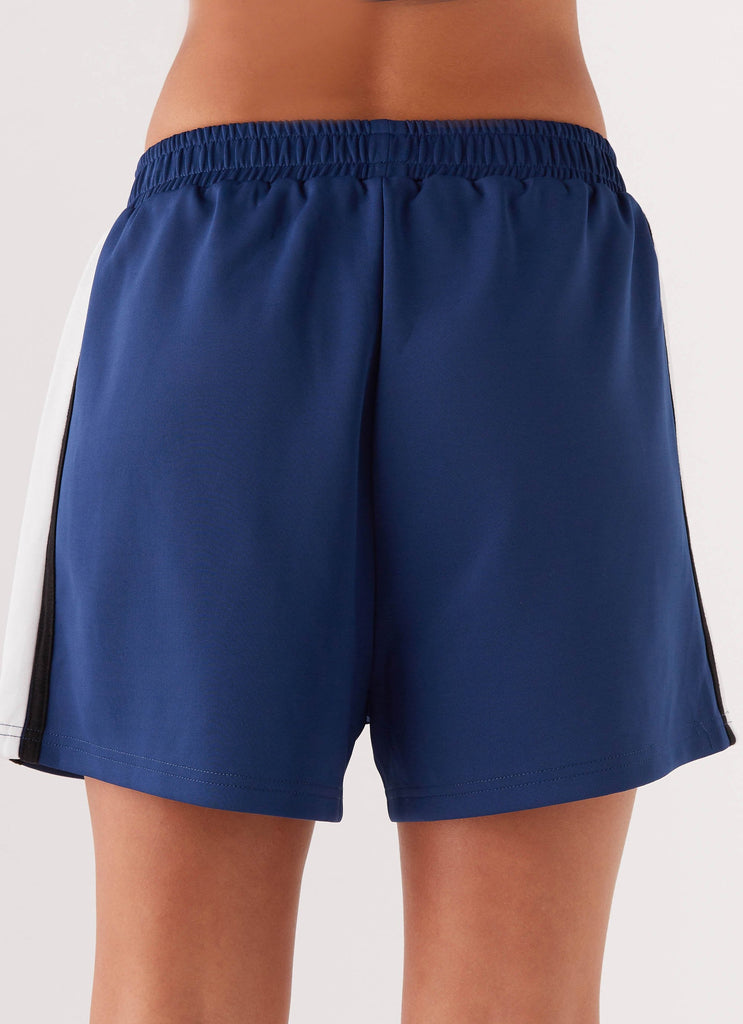 Womens Feel The Rush Track Shorts in the colour Vintage Blue in front of a light grey background