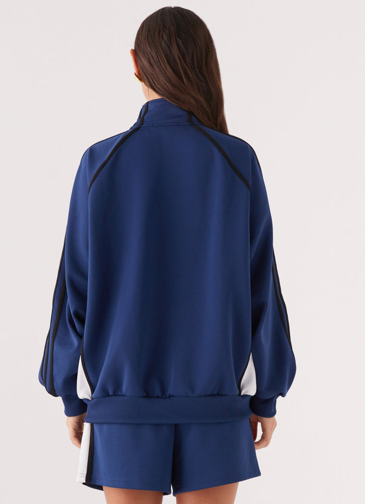 Womens Feel The Rush Track Jacket in the colour Vintage Blue in front of a light grey background