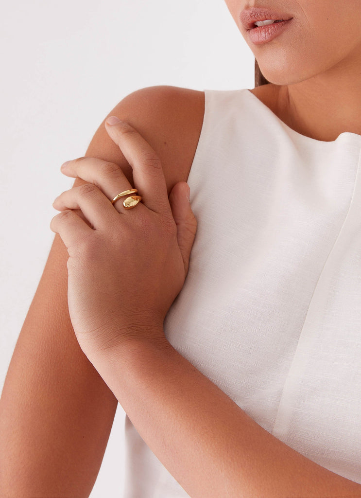 Womens Teardrop Wrap Ring in the colour Gold in front of a light grey background