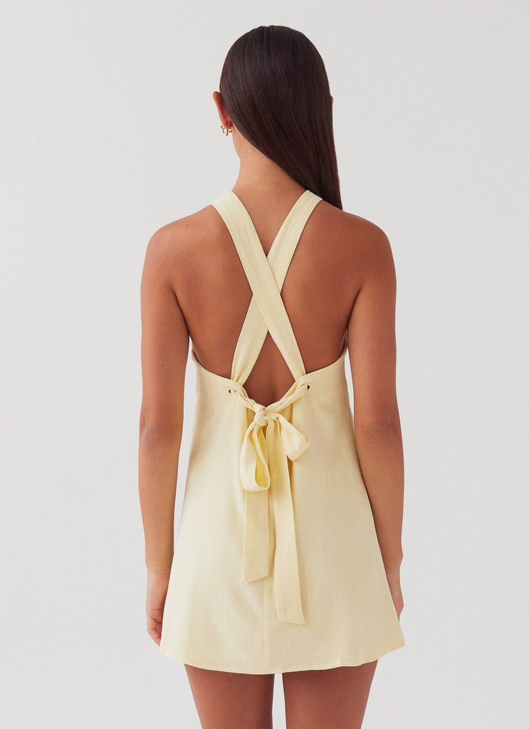 Womens Keira Linen Mini Dress in the colour Lemon in front of a light grey background