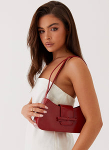 Womens Cara Bow Shoulder Bag in the colour Red in front of a light grey background