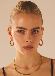 Womens Keep Frontin Hoop Earrings in the colour Gold in front of a light grey background