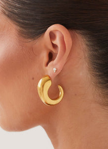 Womens Glow Girl Hoop Earrings in the colour Gold in front of a light grey background