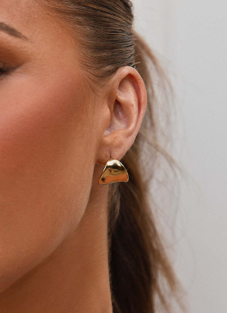 Womens Nova Earrings in the colour Gold in front of a light grey background